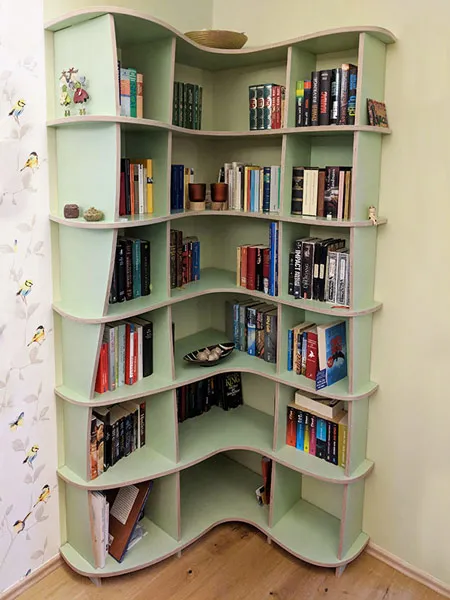 Mint green corner shelf with books