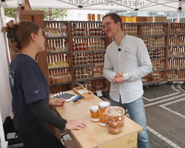 Julius im Kundengespräch am Honighalle-Marktstand