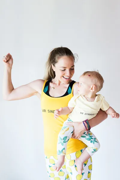 Anna Lena Kramss does power pose with baby