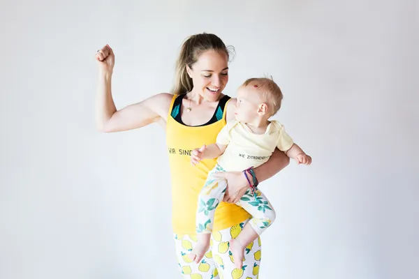 Anna Lena Kramss does power pose with baby