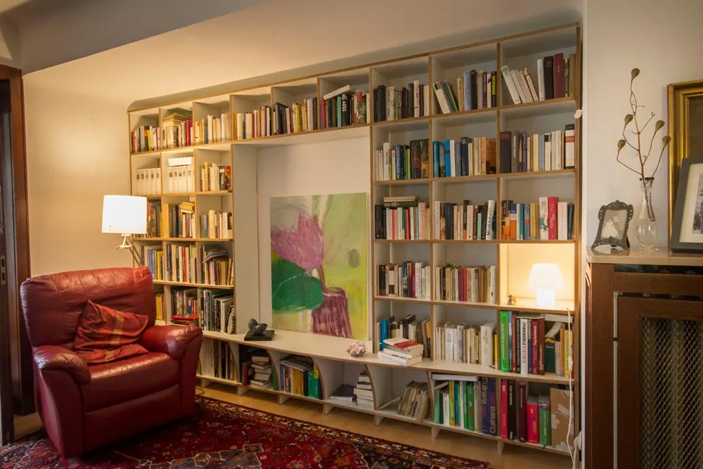 Home library with armchair and floor lamp