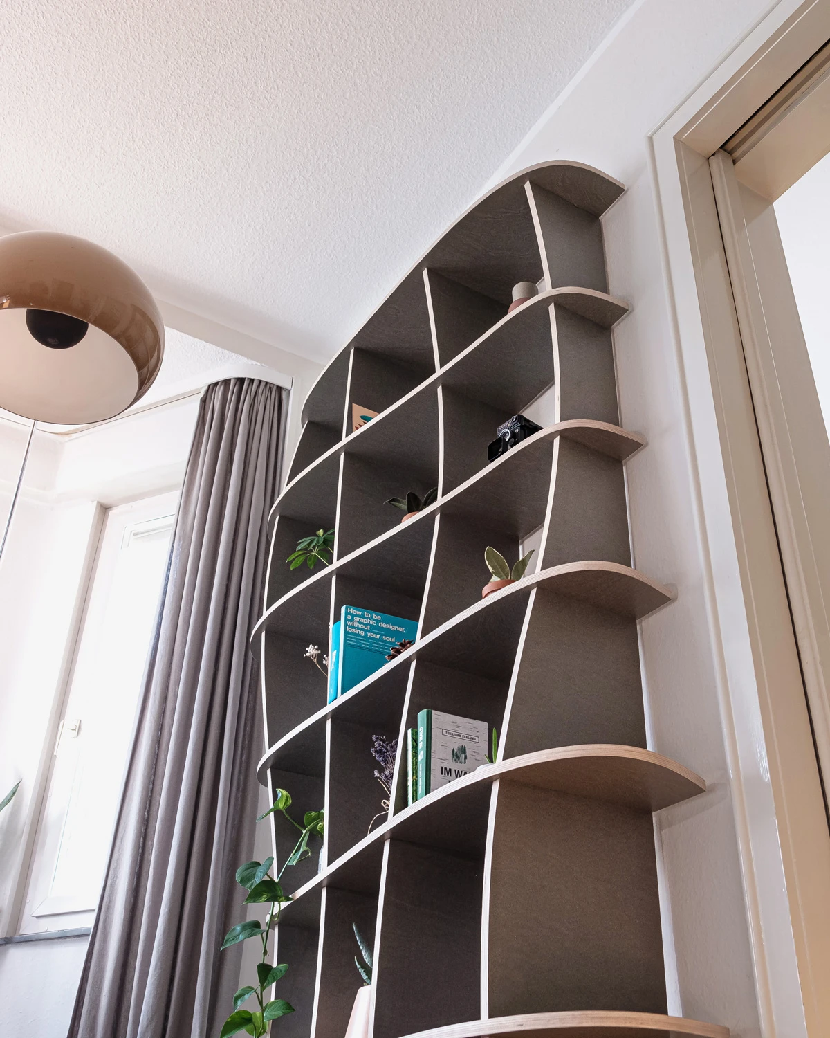 Low-angle view of a gray organic bookshelf