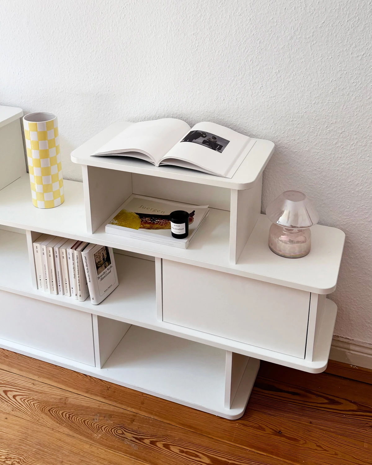 Close-up of a white sideboard with staggered compartments